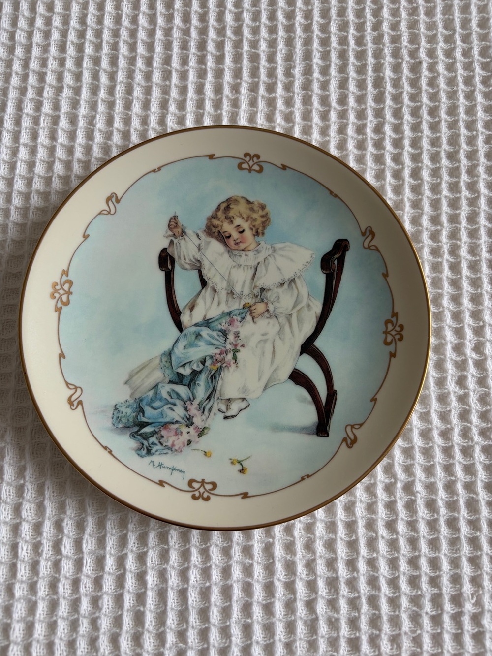Porcelain Decorative Plate with Blue Pastel Child Motif and Gold Trim